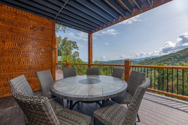 Outdoor dining space for 8 at Black Bears & Biscuits Lodge, a 6 bedroom cabin rental located in Pigeon Forge